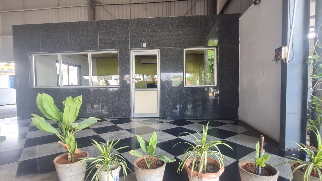 Site office clad in Steel Grey granite, with potted plants on a chequered granite floor